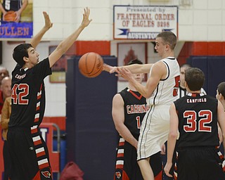 Katie Rickman | The Vindicator.Canfield's Sam Digiocomo (42)  blocks the pass of Austintown's Jake Bullen (5) during the first period at Austintown High School on Friday, Dec. 2, 2015.