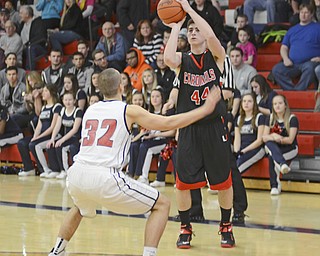 Katie Rickman | The Vindicator.Canfields Mason Mangapora (44) shoots as Austintown's Dominic DiFrancesco (32) during the first period at Austintown High School on Friday, Dec. 2, 2015.