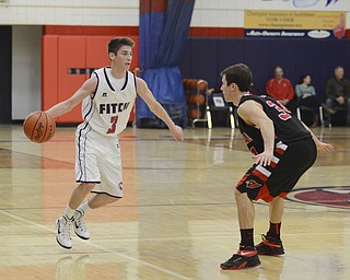 Katie Rickman | The Vindicator.Fitch's Scotty Duffy (3) is guarded by Canfield's Vince Leone (34) as Duffy moved up the court during the second period during the game at Fitch High School on Friday, January 2, 2015.