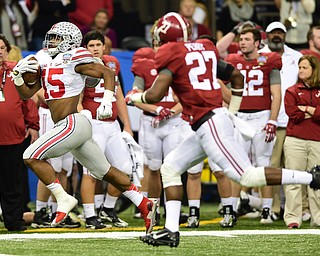 NEW ORLEANS, LOUISIANA - JANUARY 1, 2015: Ezekiel Elliott #15 of Ohio State runs in the open field away from Derrick Henry #27 of Alabama during the 1st quarter of Thursday nights game at the Superdome. (Photo by David Dermer/Youngstown Vindicator)