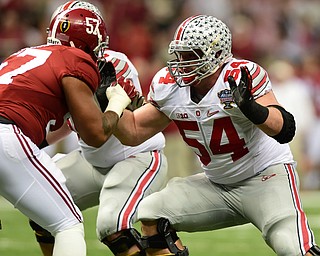 NEW ORLEANS, LOUISIANA - JANUARY 1, 2015: Billy Price #54 of Ohio state sets up to block D.J. Pettway #57 of Alabama during the 1st quarter of Thursday nights game at the Superdome. (Photo by David Dermer/Youngstown Vindicator)