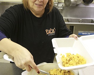 William D. Lewis theVindicator  Jeanette Morales serves up rice at the popular eatery now located on Belmont Ave. in Liberty.