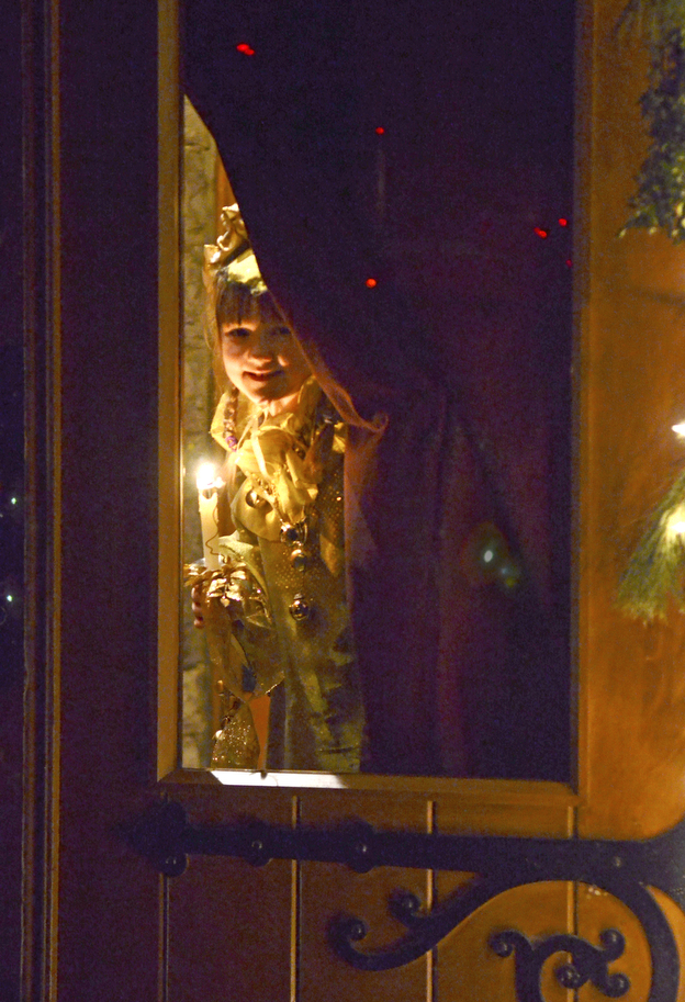 Katie Rickman | The Vindicator.Leah Wiodarski plays the part of a Sprite as she peeks through the glass door before skipping down the isle during the 54th annual Boar's Head & Yule Log Festival at St. John's Episcopal Church on Sunday, Jan. 4, 2014.