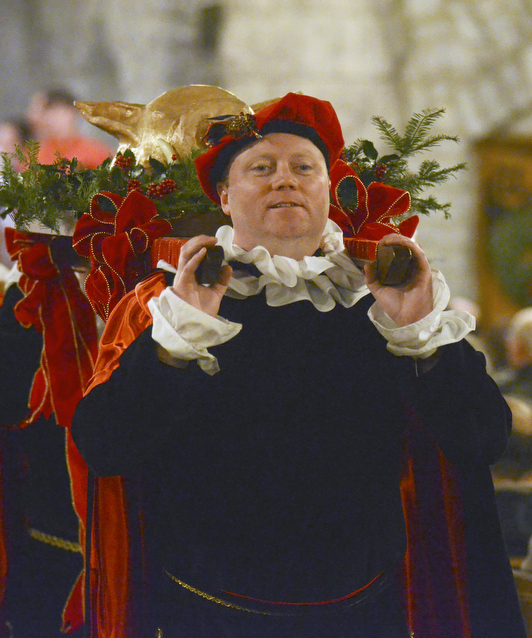 Katie Rickman | The Vindicator.Jason Lisko carries the boars head in with the help of Walt Baver during the 54th annual Boar's Head & Yule Log Festival at St. John's Episcopal Church on Sunday, Jan. 4, 2014.