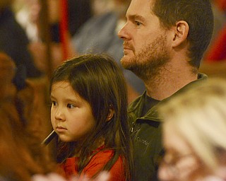 Katie Rickman | The Vindicator.Matt Shears of Berkeley, California holds his daughter 6-year-old daughter Amelie during the 54th annual Boar's Head & Yule Log Festival at St. John's Episcopal Church on Sunday, Jan. 4, 2014.