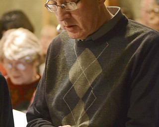 Katie Rickman | The Vindicator.Donald Rota of Girard sings a song from a hymnal during the 54th annual Boar's Head & Yule Log Festival at St. John's Episcopal Church on Sunday, Jan. 4, 2014.