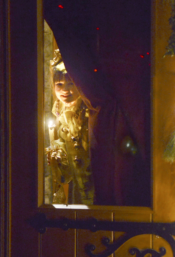 Katie Rickman | The Vindicator
Leah Wiodarski plays the part of a Sprite as she peeks through the glass door before skipping down the isle during the 54th annual Boar's Head & Yule Log Festival at St. John's Episcopal Church on Sunday, Jan. 4, 2014.