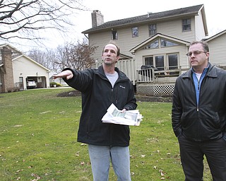 William d Lewis the vindicator  Dave Carelli, left, stands in the backyard of his home @ 3712 Tippecanoe Pl. in Canfield. He is complaining about water problems. With him is Canfield trustee Brian Governor.