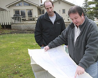 William d Lewis the vindicator  Dave Carelli, left, stands in the backyard of his home @ 3712 Tippecanoe Pl. in Canfield. He is complaining about water problems. With him is Tim Burkert from the Mahoning County Engineeers office.