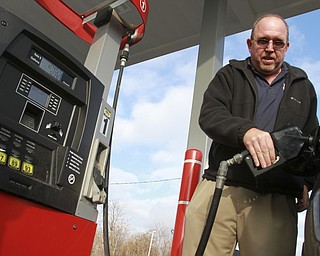 William D. Lewis The Vindicator  Mike Ash of Columbiana fills up at Jordan's Gas Mart on Market St in 12/29/14. Gas was selling for $1.99/gal.