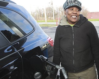 William D. Lewis The Vindicator  Janet Green of youngstown fills up at Jordan's GasMart on Market St in Youngstown,she talks about gas being below $2/gallon 12/29/14.