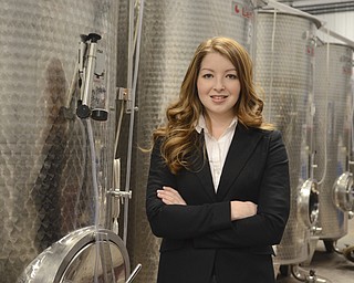Katie Rickman | The Vindicator.Marisa Sergi, 21 of Youngstown stands near wine making equipment at Luva Bella Winery in Lowellville on Tuesday, Dec. 30, 2014. Sergi is a senior at Cornell University and as a part of a final project developed a start-up called RedHead Wine.