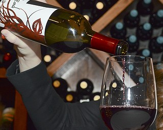 Katie Rickman | The Vindicator.Marisa Sergi, 21 of Youngstown pours her wine at Luva Bella Winery in Lowellville on Tuesday, Dec. 30, 2014. Sergi is a senior at Cornell University and as a part of a final project developed a start-up called RedHead Wine.