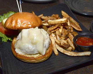 Katie Rickman | The Vindicator.The V2 burger features hot peppers, fontina cheese, onions, golden BBQ sauce, lettuce, tamato, and grilled brioche and runs for $9.50.