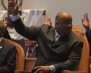 Key speaker Reverand Michael Harrison raises his hand in worship with the choir during the Emancipation Proclamation and Installment service at the New Bethel Baptist Church in Youngstown on Thursday morning.  Dustin Livesay  |  The Vindicator  1/1/15  Youngstown, Ohio.