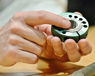 Jeff Lange | The Vindicator  CEO of Drake Manufacturing James L. Vosnik points to threads ground by Drake machines, Monday morning at the manufacturing plant.
