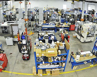 Jeff Lange | The Vindicator  A lone employee works on a ball nut grinder in the machine-filled plant, Monday morning at the Drake Manufacturing plant in Warren.