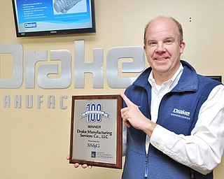Jeff Lange | The Vindicator  CEO of Drake Manufacturing Services Co. James L. Vosnik stands with the plaque awarded to the company for placing 36th in the 2014 Weatherhead 100 Winners, Monday morning at the Drake Manufacturing plant in Warren.