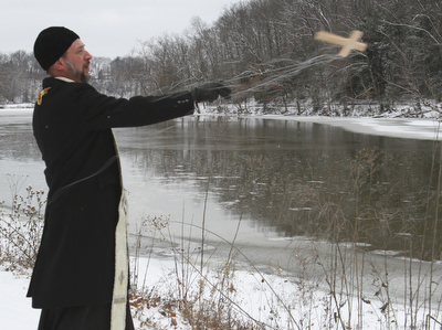 William D. Lewis The Vindicator   Rev Andrew Nelko of St John the Baptist in Campbell throws a crucifix into Lake Glacier during annual Orthodox Blessing of the Water at Mill Creek Park  Tuesday 1-6-15.