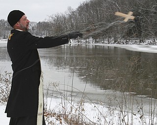 William D. Lewis The Vindicator   Rev Andrew Nelko of St John the Baptist in Campbell throws a crucifix into Lake Glacier during annual Orthodox Blessing of the Water at Mill Creek Park  Tuesday 1-6-15.