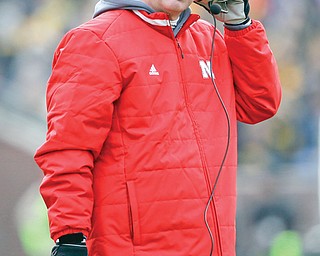 Former Nebraska head coach Bo Pelini looks on during the first half of a game against Iowa. Pelini is busy settling in as the new coach at Youngstown State.
