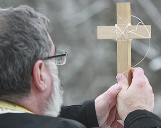 William D. Lewis The Vindicator  Rev. Thomas Constantine,holds a crucifix during annual Orthodox Blessing of the Water at Mill Creek Park  Tuesday 1-6-15.