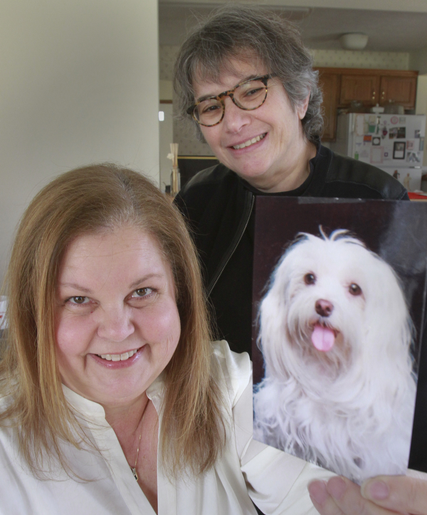 William D. Lewis the vindictor Joni Vernars, left, and Lisa Nassief with a photo Vernars former pet and therapy dog Sasha.