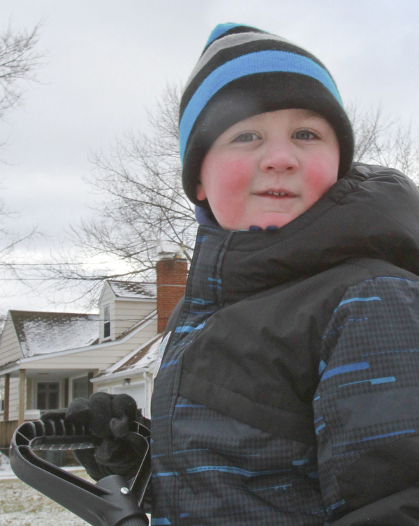 William D. Lewis the vindictor  Ethan Datko, 5, shovels snow in the driveway of his Boardman home Monday Jan. 5, 2015. The area got a light dusting of snow Monday but more is expected this week.He is son of John and Pamela Datko.