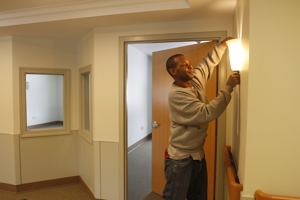        ROBERT K. YOSAY  | THE VINDICATOR..Brian Chaney.. electrician adjusts a light . The dual pane windows are used in the Alzheimers wing to help see the residents without haveing to open the doors. disturbing the residents..The Antonine Sisters - Antonine Village, a new $9 million assisted living and memory care center that will complement their adult day care facility in this peaceful, rural setting. Construction nearly completed for an opening on Jan. 18. on Lipkey Rd in North Jackson. .