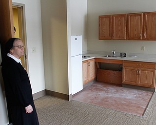        ROBERT K. YOSAY  | THE VINDICATOR..Sister Marie Madeleine Iskandar,  Superior looks over the kitchen area...  of one of the 10 Assisted rooms....The Antonine Sisters - Antonine Village, a new $9 million assisted living and memory care center that will complement their adult day care facility in this peaceful, rural setting. Construction nearly completed for an opening on Jan. 18. on Lipkey Rd in North Jackson. .
