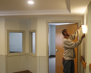        ROBERT K. YOSAY  | THE VINDICATOR..Brian Chaney.. electrician adjusts a light . The dual pane windows are used in the Alzheimers wing to help see the residents without haveing to open the doors. disturbing the residents..The Antonine Sisters - Antonine Village, a new $9 million assisted living and memory care center that will complement their adult day care facility in this peaceful, rural setting. Construction nearly completed for an opening on Jan. 18. on Lipkey Rd in North Jackson. .