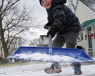 William D. Lewis the vindictor  Ethan Datko, 5, shovels snow in the driveway of his Boardman home Monday Jan. 5, 2015. The area got a light dusting of snow Monday but more is expected this week.He is son of John and Pamela Datko.