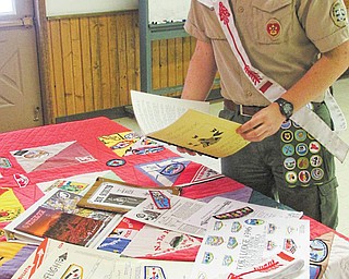 SPECIAL TO THE VINDICATOR — Seth Welch looks over some of the history collection gathered by the Greater Western Reserve Boy Scout Council Lodge known as Wapashuwi Lodge 56.