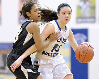 Lakeview’s Annie Pavlansky (10) gets past Harding’s Alasjia Dykes during the first half of their game Wednesday at Lakeview High School in Cortland. Pavlansky made 8 of 8 free throws and had 16 points total for the Bulldogs, who downed the Raiders, 58-48.