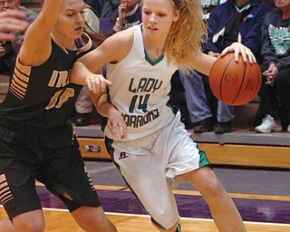 West Branch guard Melinda Trimmer drives toward the basket against St. Vincent-St. Mary defender Shannon Jack
in the first half of the 2014 Division II regional final at Barberton High School. Playing college basketball has always been a dream for Trimmer, who will continue her career at Youngstown State University.