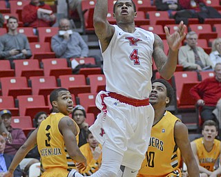 Katie Rickman | The Vindicator.Youngstown's Shawn Amiker (4) goes up for a shot during the first period against Wright State Thursday, January 8, 2015.