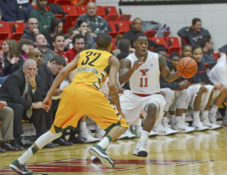 Katie Rickman | The Vindicator.Youngstown's DJ Cole (11) moves up court and is blocked by Wright State's Joe Thomasson (32) during the first period at YSU on Jan. 8, 2015.
