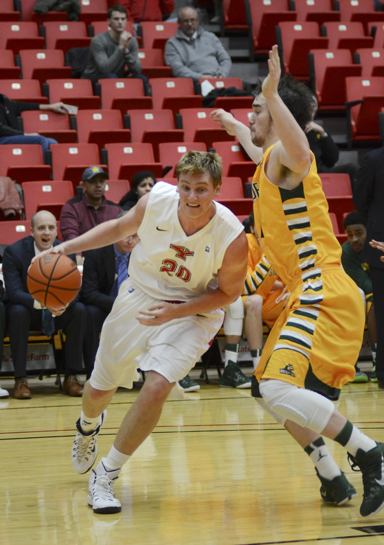 Katie Rickman | The Vindicator.Youngstown's Bobby Hain (20) pushes past Wright State's Kendall Griffin (15) before going up for a shot and scoring during the first period on Jan. 8, 2015.