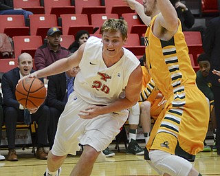 Katie Rickman | The Vindicator.Youngstown's Bobby Hain (20) pushes past Wright State's Kendall Griffin (15) before going up for a shot and scoring during the first period on Jan. 8, 2015.