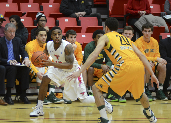 Katie Rickman | The Vindicator.Youngstown's Marcus Keene (10) moves up court and is blocked by Wright State's Chrishawn Hopkins (20) during the first period on Jan. 8, 2015.