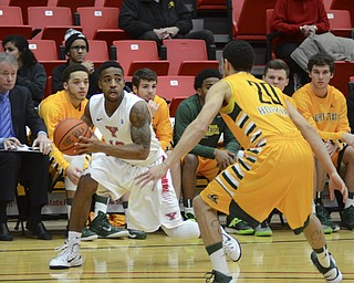Katie Rickman | The Vindicator.Youngstown's Marcus Keene (10) moves up court and is blocked by Wright State's Chrishawn Hopkins (20) during the first period on Jan. 8, 2015.