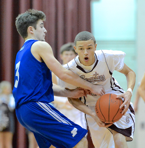 Jeff Lange | The Vindicator  Boardman's Gannon Murray (right) takes the ball past Poland's Nick Gaydos (3) in the first period of Friday night's matchup at Boardman High School.
