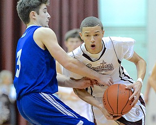 Jeff Lange | The Vindicator  Boardman's Gannon Murray (right) takes the ball past Poland's Nick Gaydos (3) in the first period of Friday night's matchup at Boardman High School.