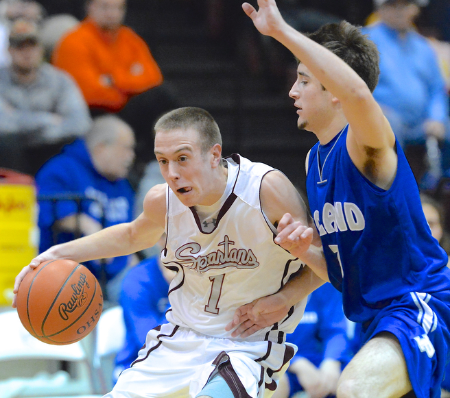 Jeff Lange | The Vindicator  Boardman's John Ryan (1) takes the ball to the hoop around Poland's Nick Gaydos (right) in the first half of Friday night's game at Boardman High School.