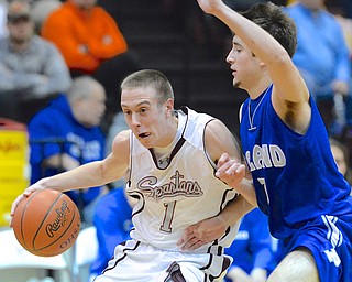 Jeff Lange | The Vindicator  Boardman's John Ryan (1) takes the ball to the hoop around Poland's Nick Gaydos (right) in the first half of Friday night's game at Boardman High School.