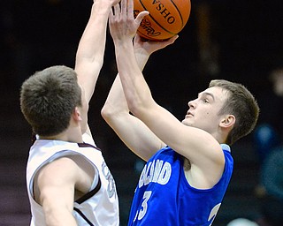 Jeff Lange | The Vindicator  Poland's Jared Burkert (right) looks over Boardman's Alex Duda (left) as he goes for a two point shot late in the fourth quarter of their matchup, Friday night in Boardman.