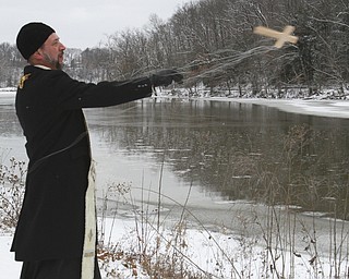 William D. Lewis The Vindicator   Rev Andrew Nelko of St John the Baptist in Campbell throws a crucifix into Lake Glacier during annual Orthodox Blessing of the Water at Mill Creek Park  Tuesday 1-6-15.
