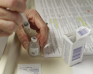 ROBERT K. YOSAY | THE VINDICATOR..Flu vaccine as Brenda Christensen RN of Mahoning County Health Dept.. administers the flu vaccine at the Mahoning County Clinic in Austintown .
