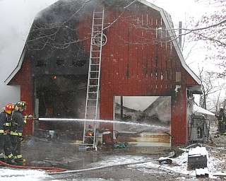        ROBERT K. YOSAY  | THE VINDICATOR..In the 5000 block of Lou Ida Drive in Austintown - Austintown, Weathersfield, FD fought a stubborn barn fire behind a house.