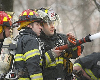        ROBERT K. YOSAY  | THE VINDICATOR..In the 5000 block of Lou Ida Drive in Austintown - Austintown, Weathersfield, FD fought a stubborn barn fire behind a house.